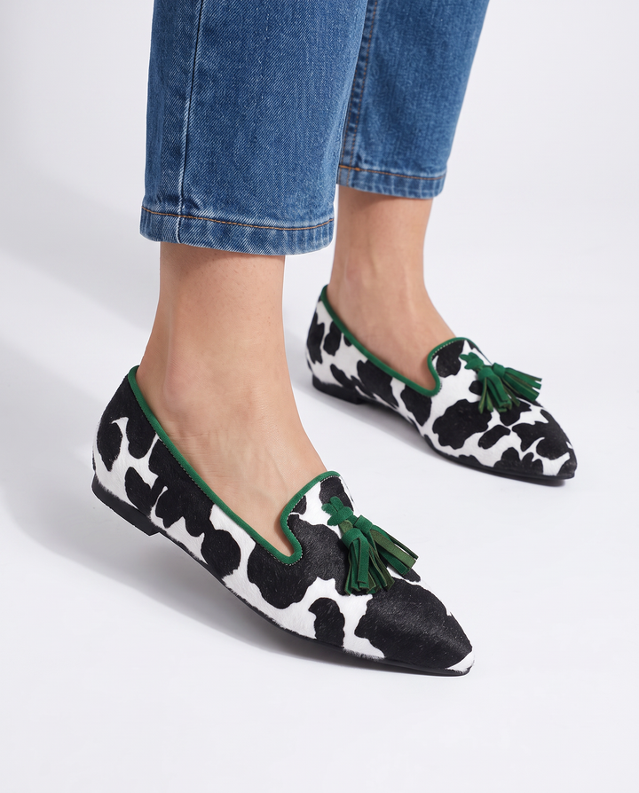 Ginevra Moccasin — Black and White Cow Print, Green Tassels